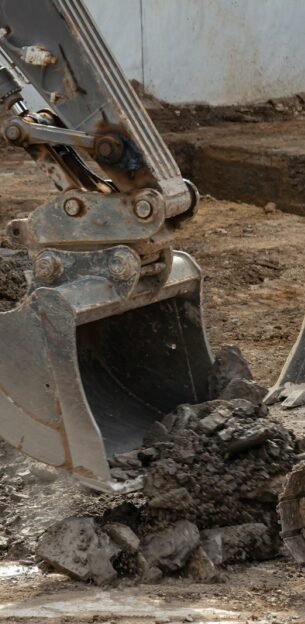 yellow and black excavator on brown soil